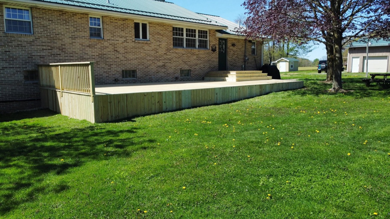 Ground-level pressure-treated deck on a brick ranch